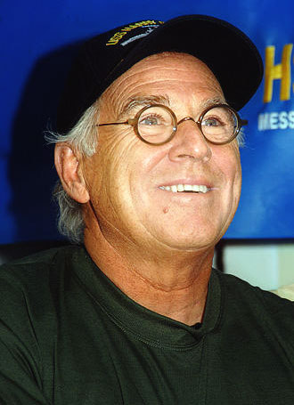 Jimmy Buffett wearing a baseball cap.